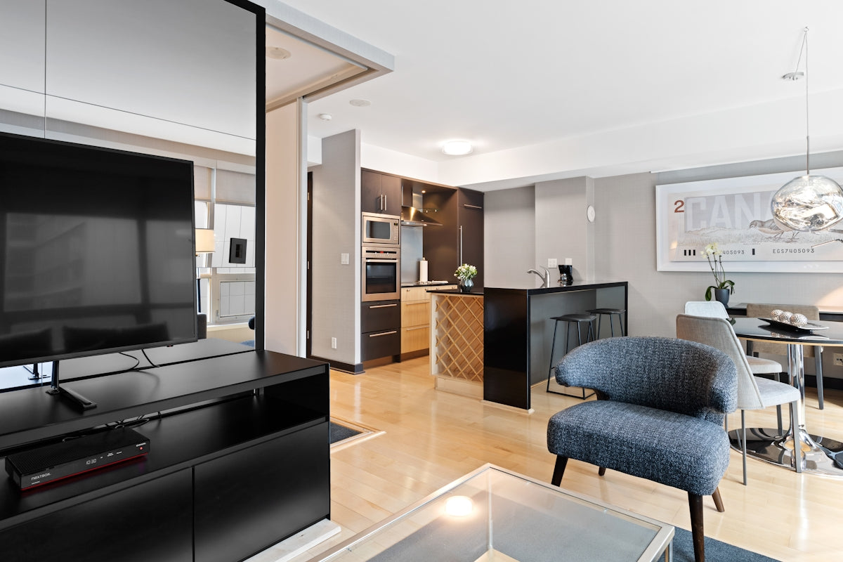 black flat screen tv on brown wooden tv rack