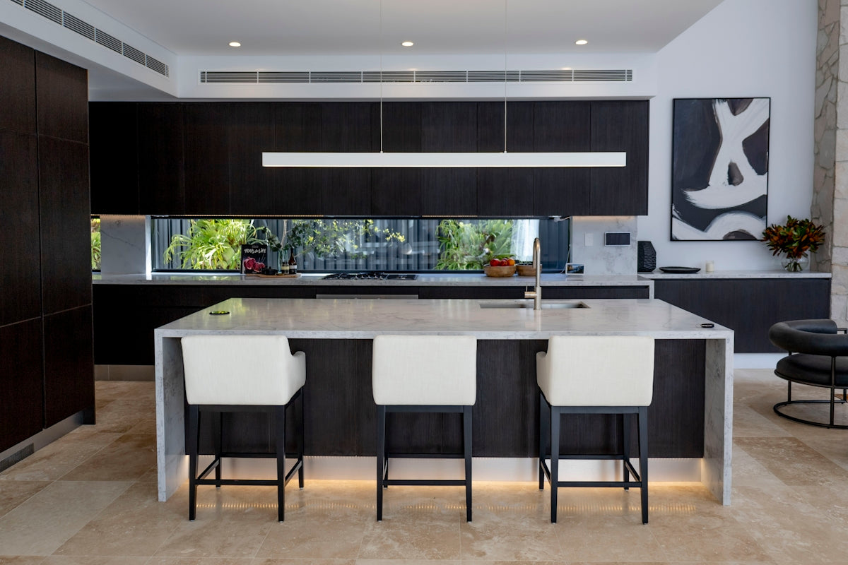 a kitchen with black cabinets