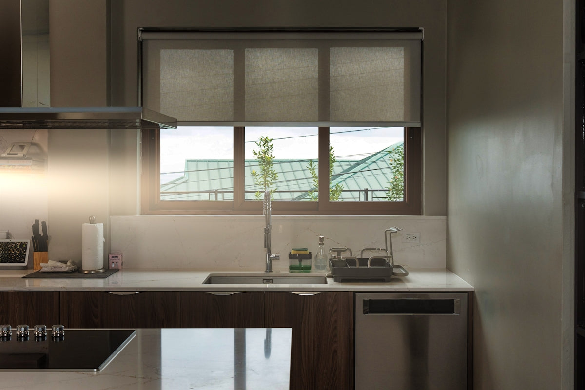 a kitchen with a sink, dishwasher and a window