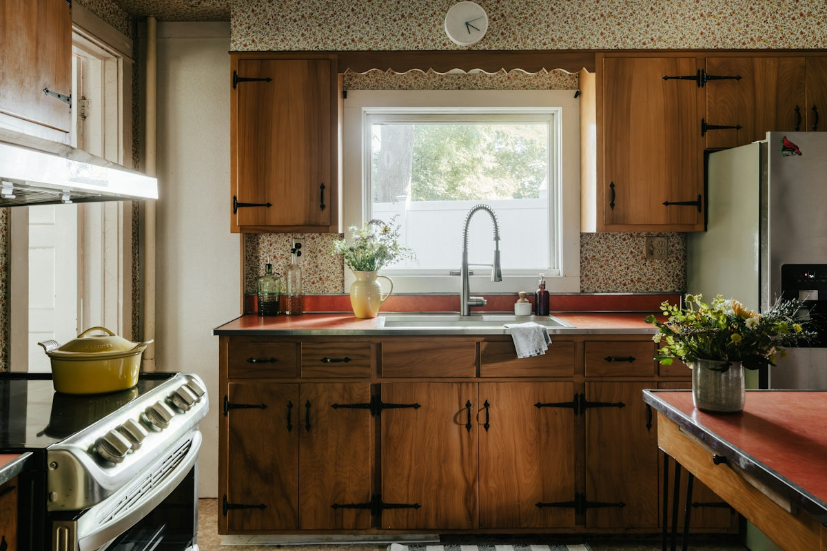 A kitchen with wooden cabinets and a stove top oven
