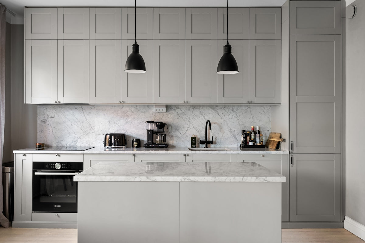 A kitchen with a stove, sink, and oven
