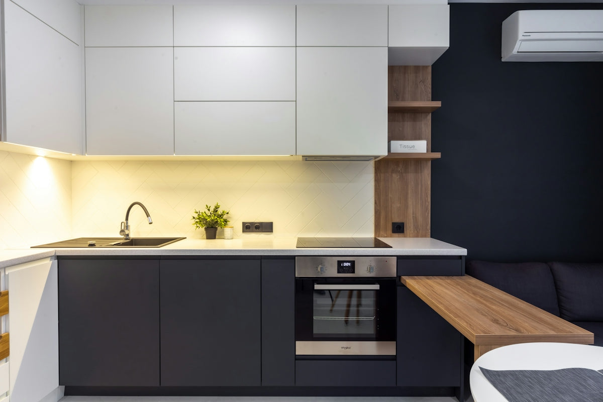 A kitchen with a couch and a sink