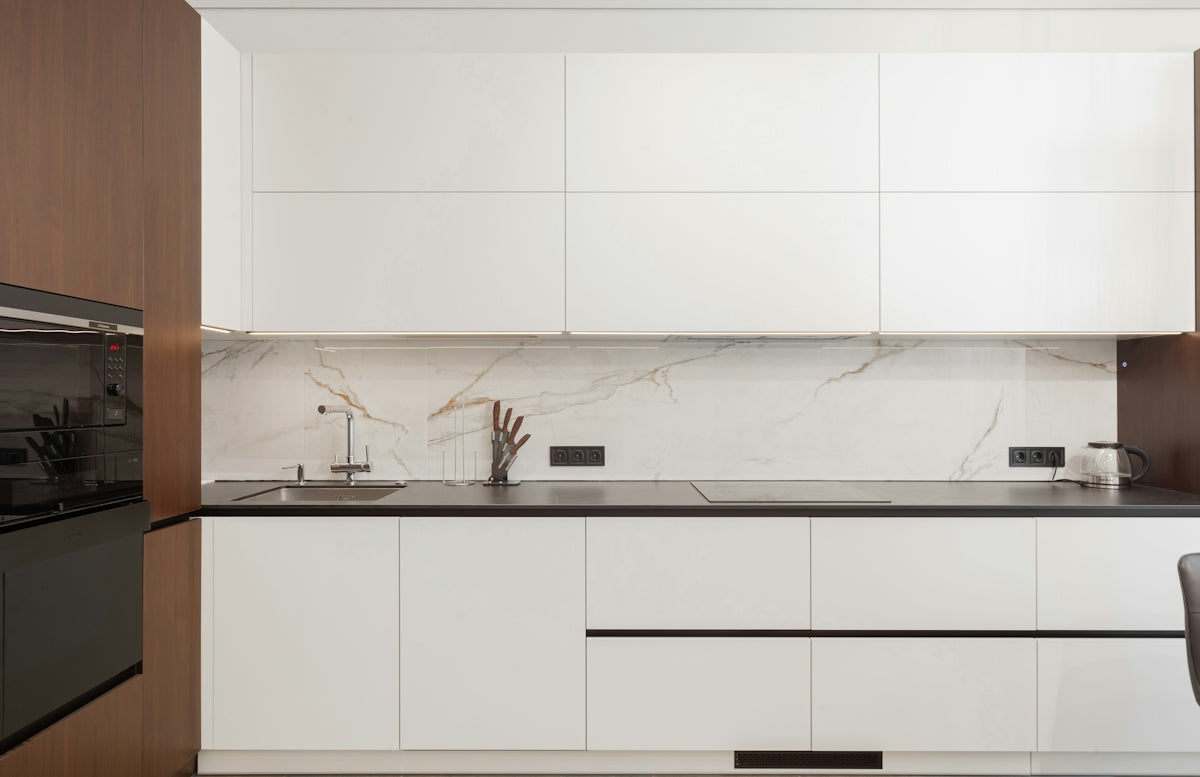 Modern kitchen with white cabinets and dark accents