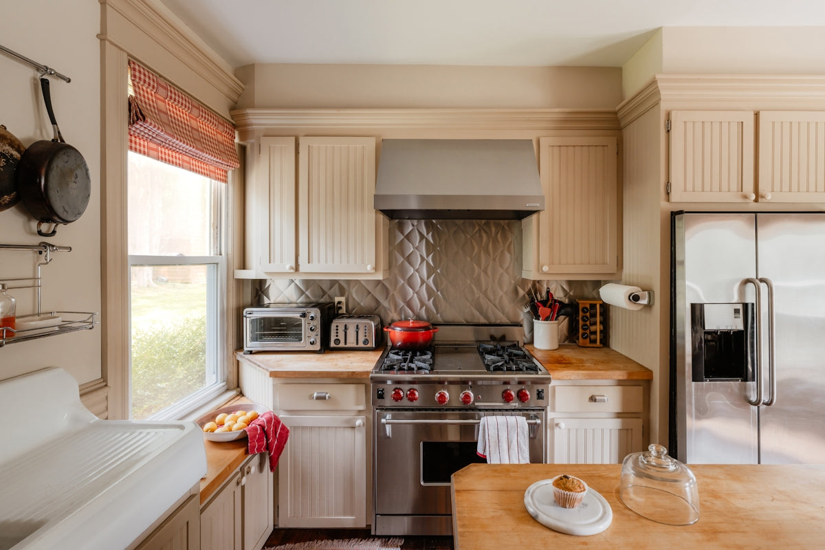 A well-lit kitchen with modern appliances is shown.