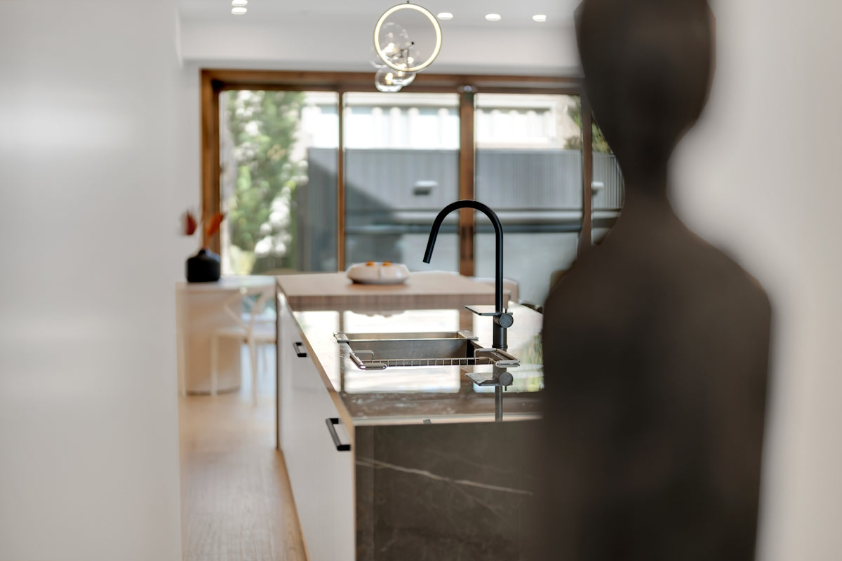 Modern kitchen island with sink and faucet.