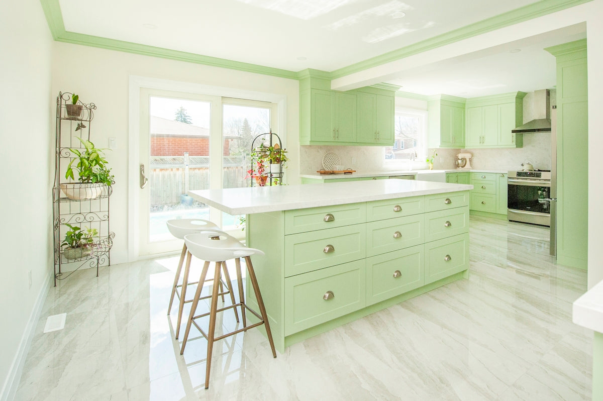 Modern kitchen with light green cabinets and island