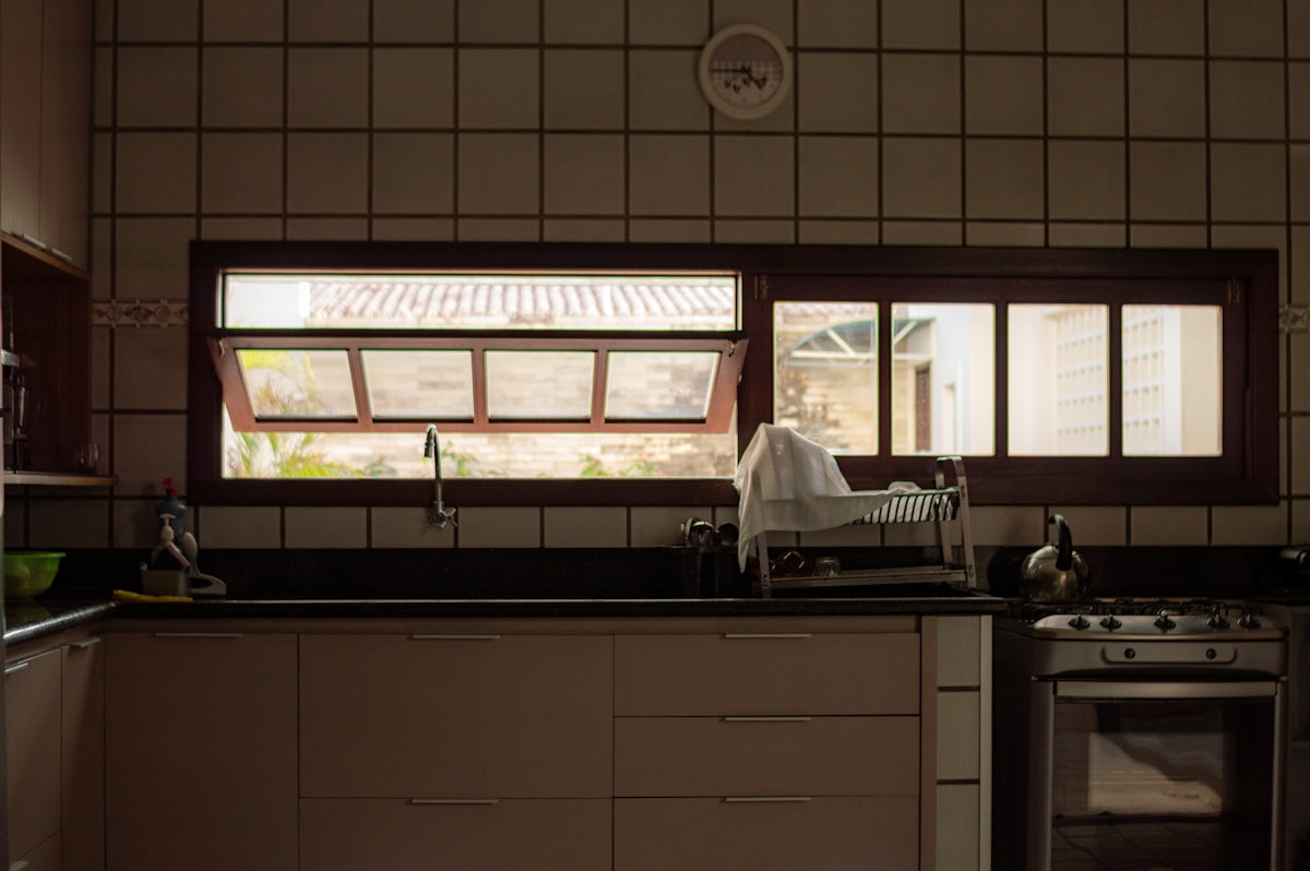 Kitchen counter with sink and window view.