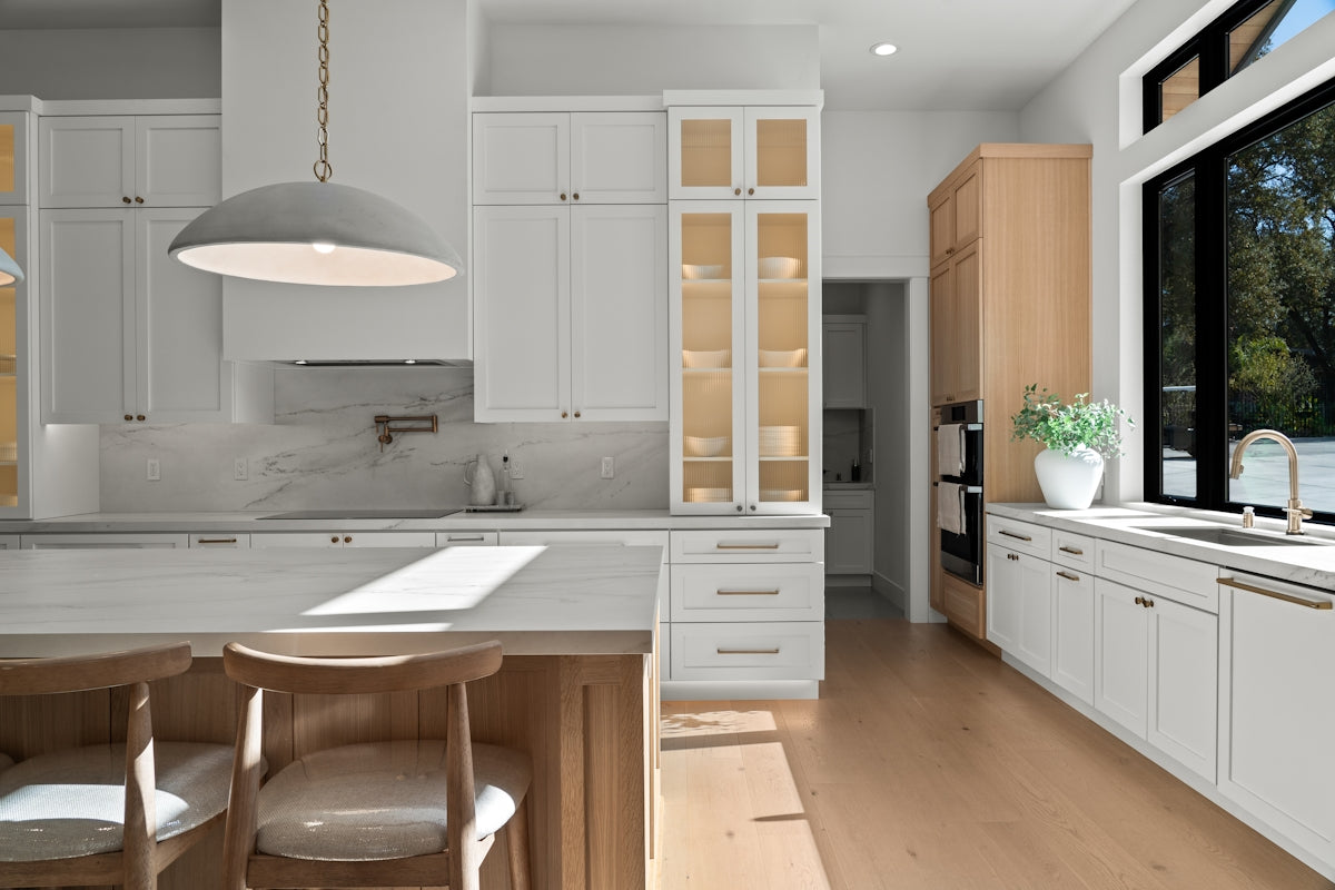 Modern white kitchen with island and large window