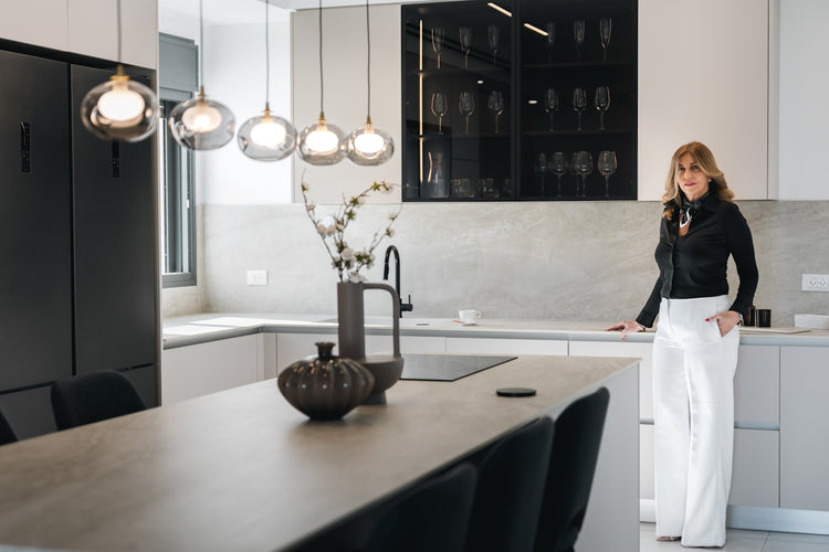 Woman standing in a modern kitchen with island