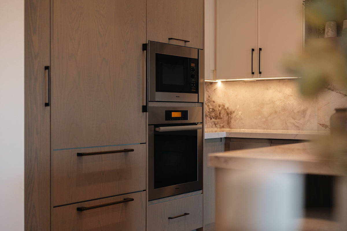 Modern kitchen with built-in oven and microwave.